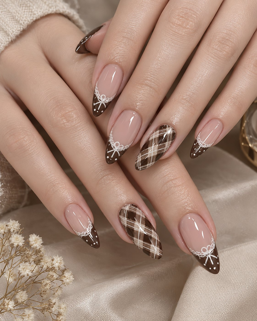 Brown French tips with white lace bows beside a brown and white plaid accent nail