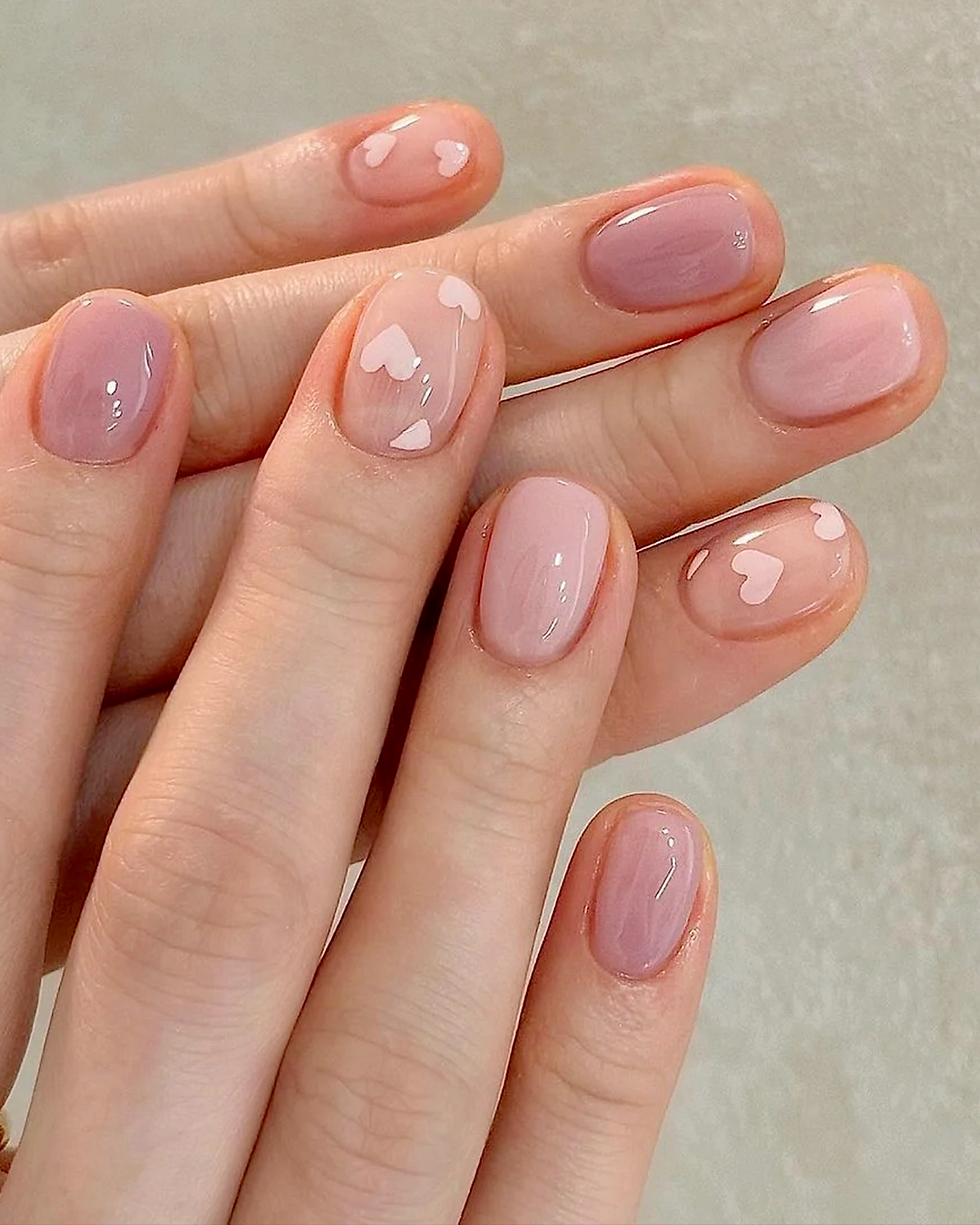 Short nails with cute heart accents and glossy pink base
