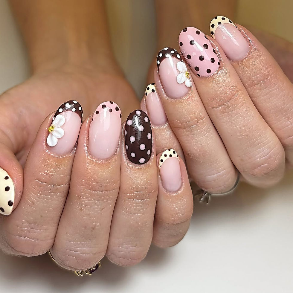 Polka dot nails in a mix of pink and chocolate brown tones, decorated with black dots and 3D white daisy flowers.