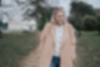 A close up photo of UK Voice Actor Emma Topping walking through a park