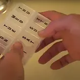 Home carer pair of hands holding medication prompt