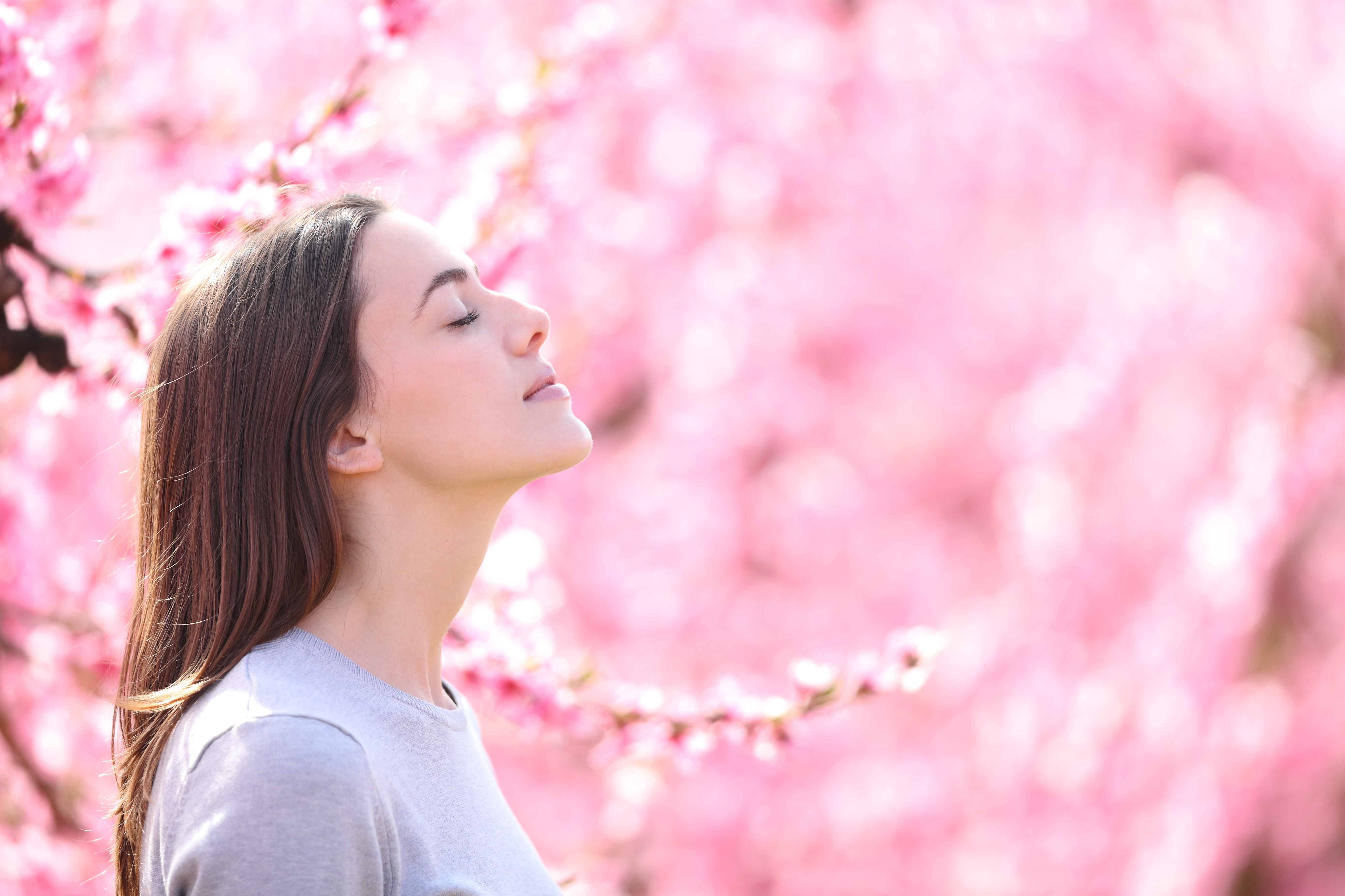Young lady outside in pink flowers