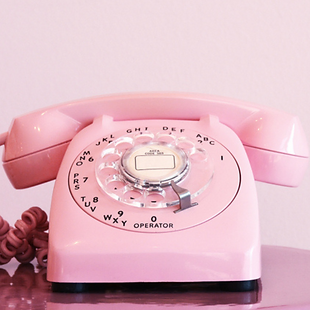 Old fashioned pink telephone to arrange domiciliary care