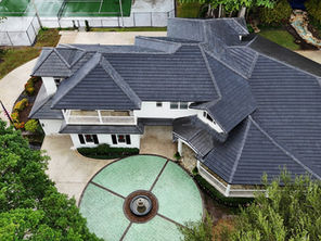 Roof replacement cost in Florida 2026 showing tile roof on South Florida coastal home