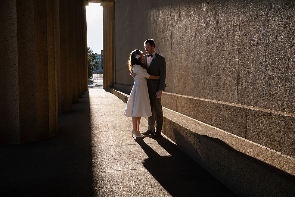 couple elopes at golden hour in nashville's parthenon in cinematic light