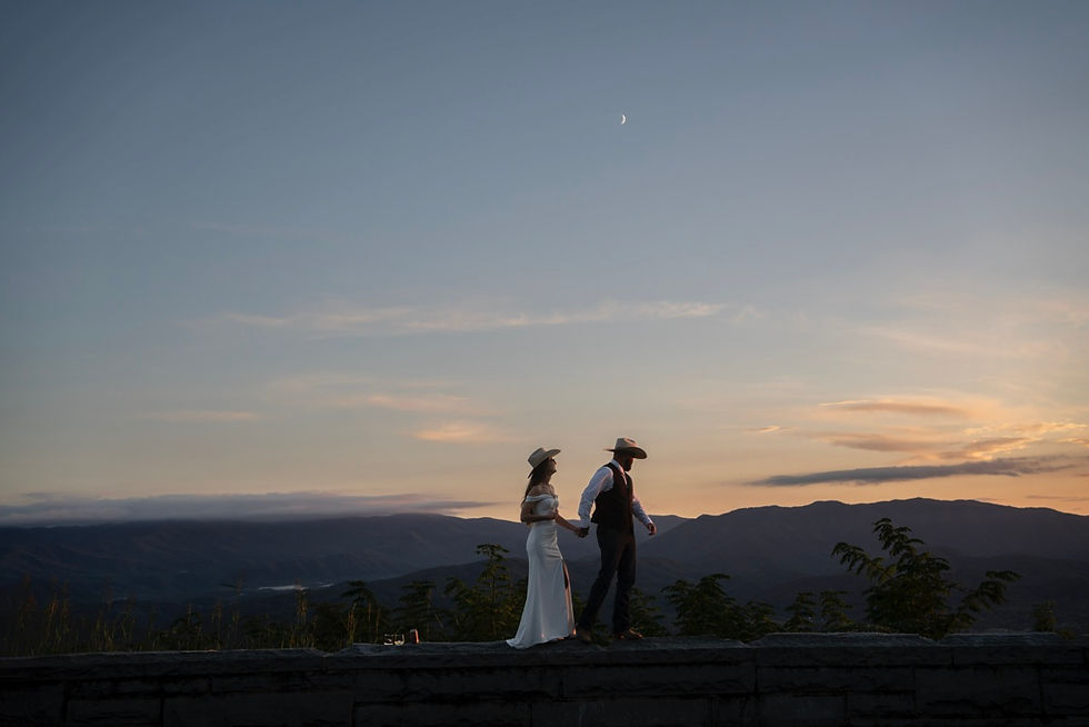 bride and groom walk along wall at caylors gap on foothills parkway