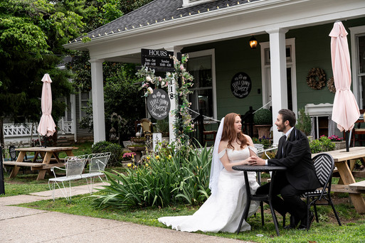 Newlyweds sharing a sweet treat during their intimate wedding experience in downtown Franklin.