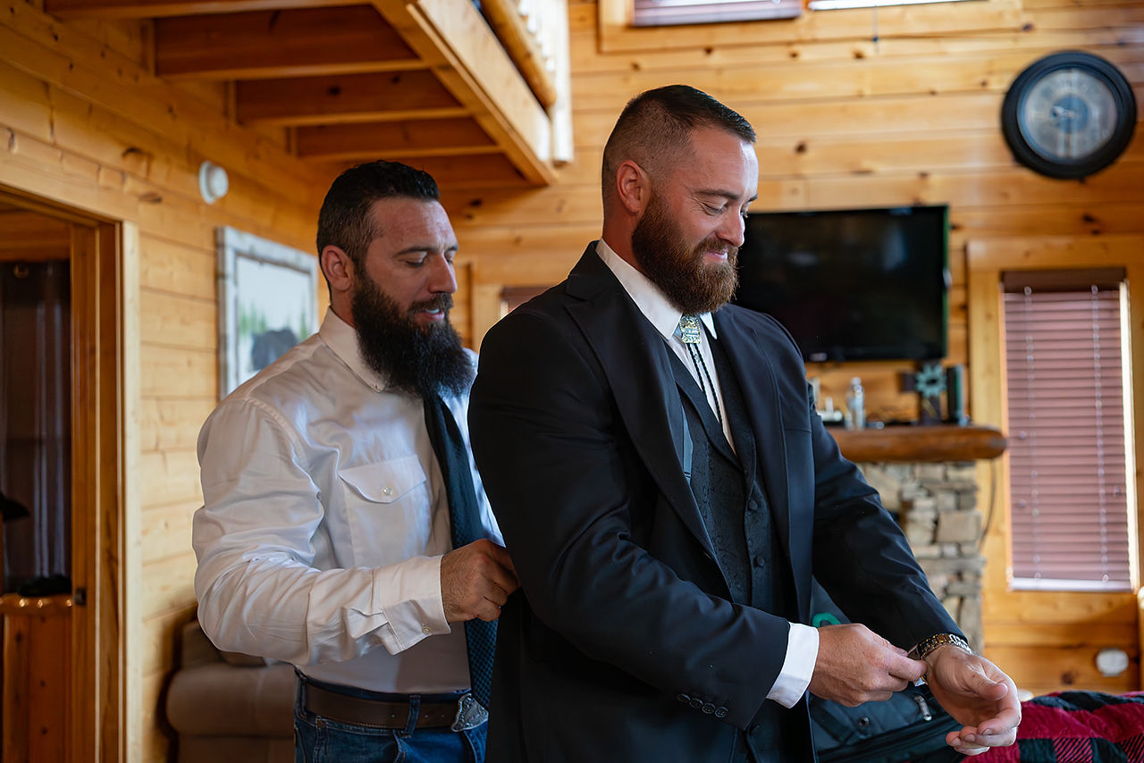 elopement groom gets ready with friend