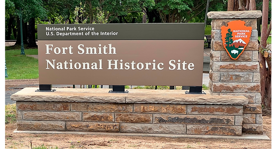 Sign for Pea Ridge National Military Park displaying the park's name and the National Park Service arrowhead emblem. [Add other visual details if relevant, like color or style if the coloring is custom