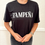 Thumbnail: A black "Tampeña" shirt