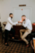Two men sitting at the bar in our Cantina smoking cigars