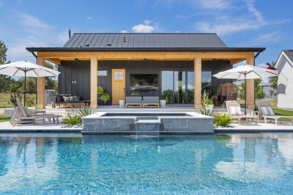 Pool side view of a casita, with patio furniture and a hot tub