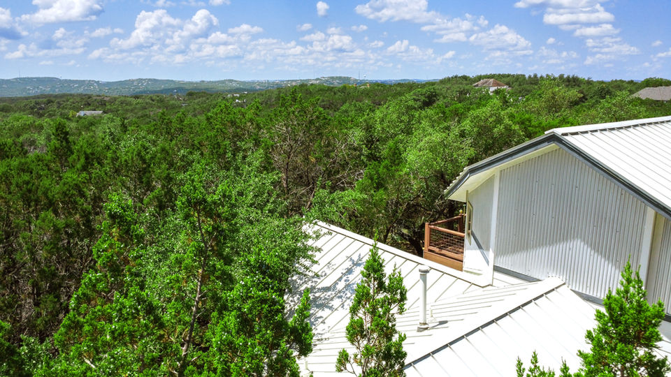 Aerial shots of a farmhouse surrounded by a forest