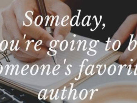 Writing on a white notebook and pen lying flat next to an laptop.