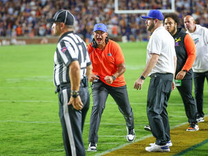 Jon Sumrall reacts on the Florida sideline with an official in the foreground.