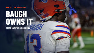 Back view of Florida running back Jadan Baugh in his white No. 13 road jersey and orange helmet, the BAUGH nameplate visible, on the sideline at Auburn, Sept. 19, 2026. Text reads Baugh Owns It, Texts Sumrall an apology. Photo by Chris Spears, GatorBait Media.