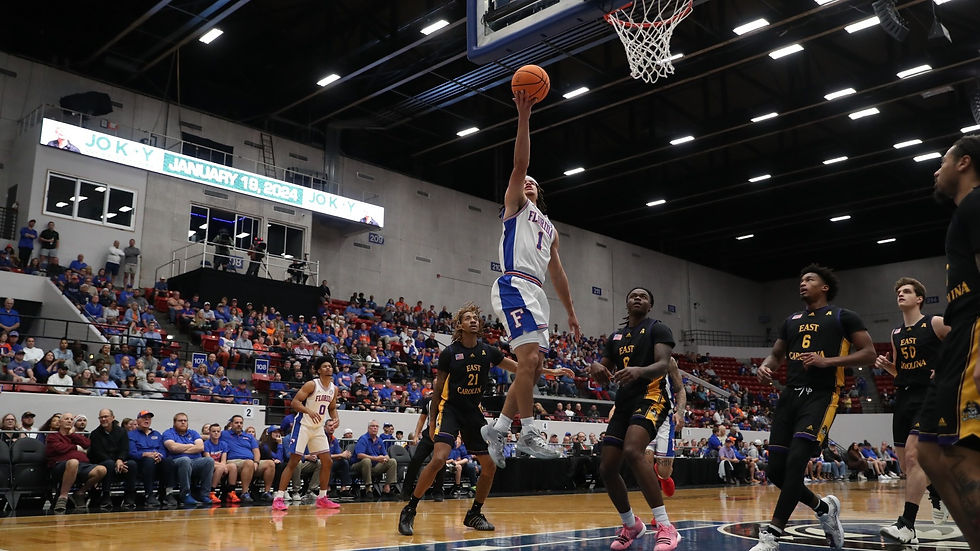 a basketball player goes in for a layup