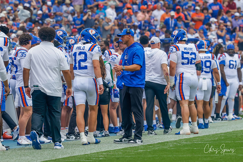 Florida quarterback Aaron Philo (No. 12) stands with head coach Jon Sumrall on the Florida sideline during the South Carolina game at Ben Hill Griffin Stadium in Gainesville.