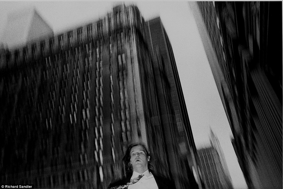 The streets of Manhattan- A suited man is captured on camera as he walks near Broadway and Wall Stre