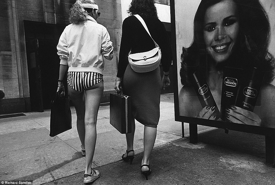 Short shorts- Two women walk together on 34th Street in 1980, one clad in extremely brief pants and 
