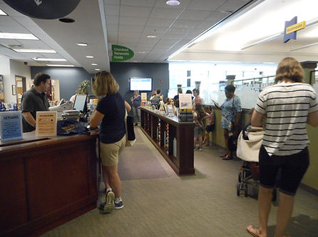 Picture of people waiting to check out items at our circulation desk.
