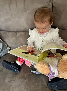 A-little-girl-reading-The -Scary-Noise-storybook