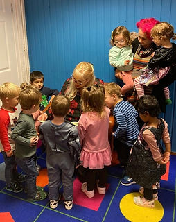 Reading-'The-Scary-Noise'-storybook-to-a-group-of-children