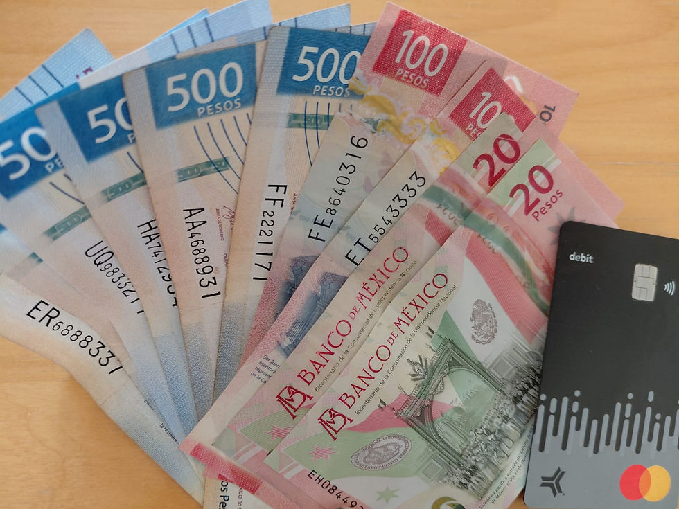 A selection of Mexican pesos and debit card