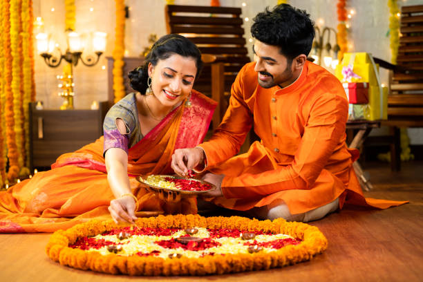 Marigold rangoli with diyas laid at a home entrance