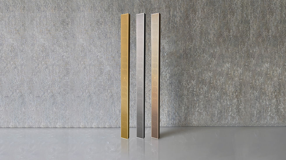Three XSCACE QuadCane Slim Array Speakers displayed vertically in a row against a textured, gray concrete wall. The speakers are shown in three different metallic finishes: Champagne Gold (left), Anthracite Gray/Silver (center), and Rose Gold/Bronze (right), highlighting their sleek, perforated grille and tall, architectural design.