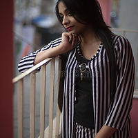 indian-bengali-brunette-girl-striped-semi-formal-wear-standing-balcony-portrait-thoughtful
