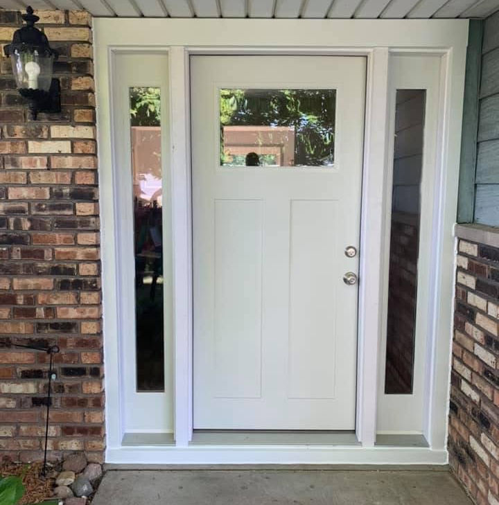 New white front entry door with a decorative glass panel and sidelights installed by Hometown Installers in Peoria, IL.