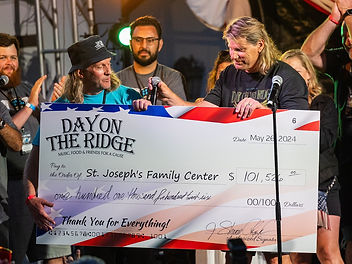 St. Joseph's board member receiving the 2024 check for 101, 526 dollars raised from our Day on the Ridge staff.