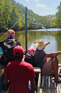 Solar equipment being transported by boat along the mangrove on the way to the farm
