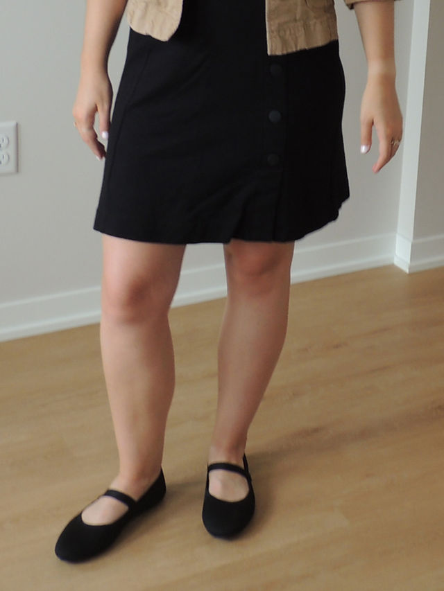 above-the-knee black skirt with black flats