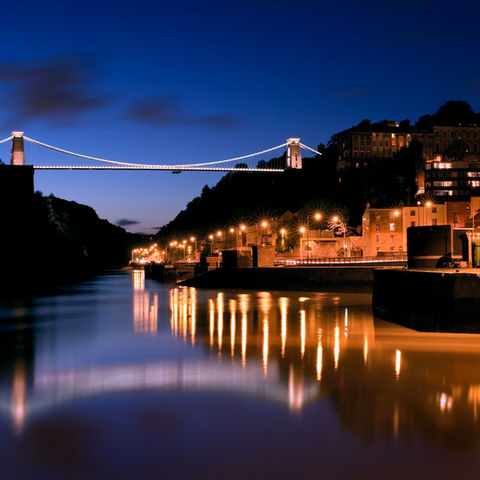An image of a lit up riverside town at night
