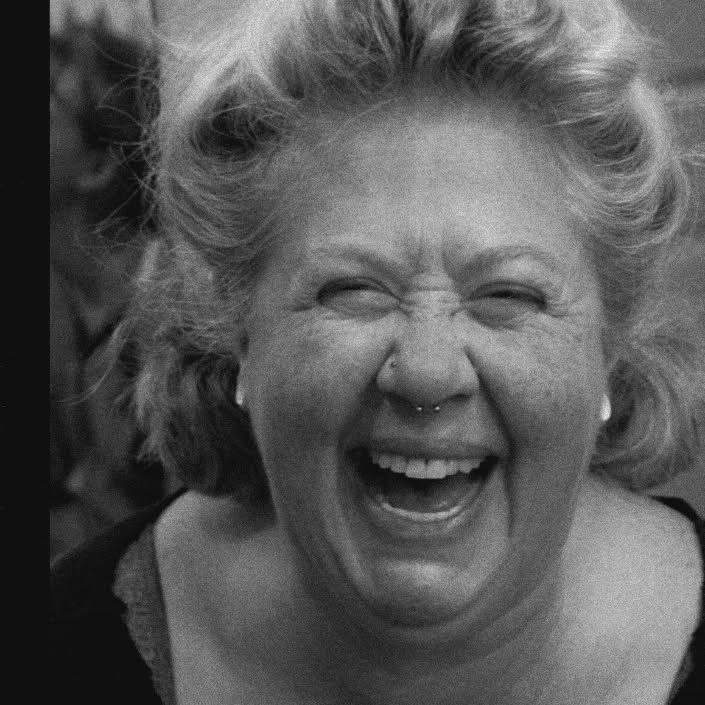 woman with a bright smile showing excitement