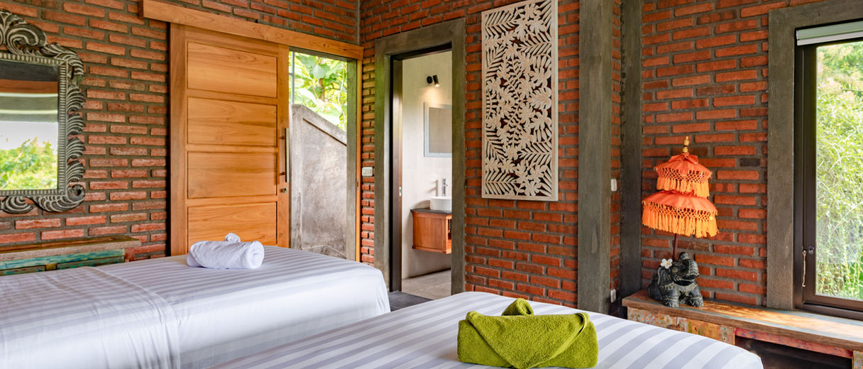 Triple bed in rustic Alamanda Resort room