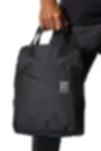 Black Shibumi Quick-Draw Side Strap bag held by someone