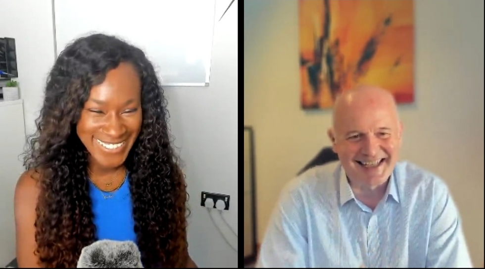 Split-screen video call with a smiling woman in a blue top and a laughing bald man in a light shirt, both in home offices.