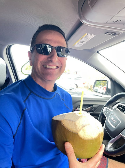 Drinking fresh coconut water in Kauai, Hawaii from a local street vendor