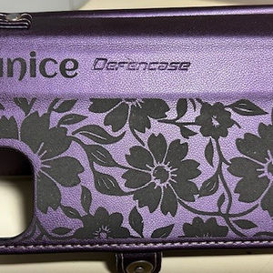 Purple phone case with Janice, Gerancase, and floral design background.