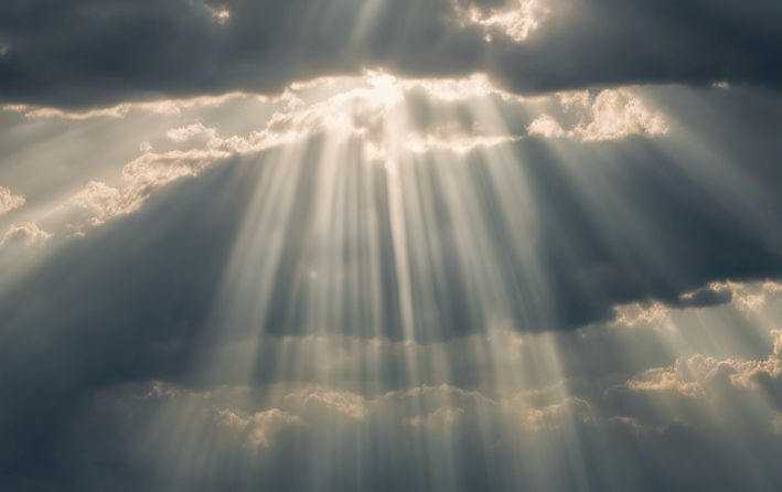 Cloudy sky with rays of sunlight shining through.jpg