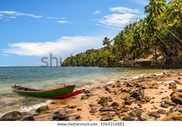 Picture clicked from a beachside of Ross Island with a small boat. Rich in flora and fauna with dense tropical forest.