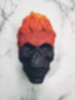 bath bomb in the shape of a black skull with flames coming out of it's head