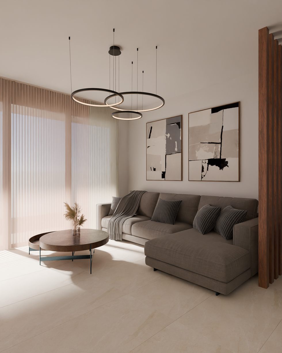 a living room with a couch and two paintings on the wall