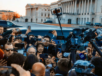 Press crowd surrounding a car, illustrating an employment dispute lawyer's confidentiality strategy