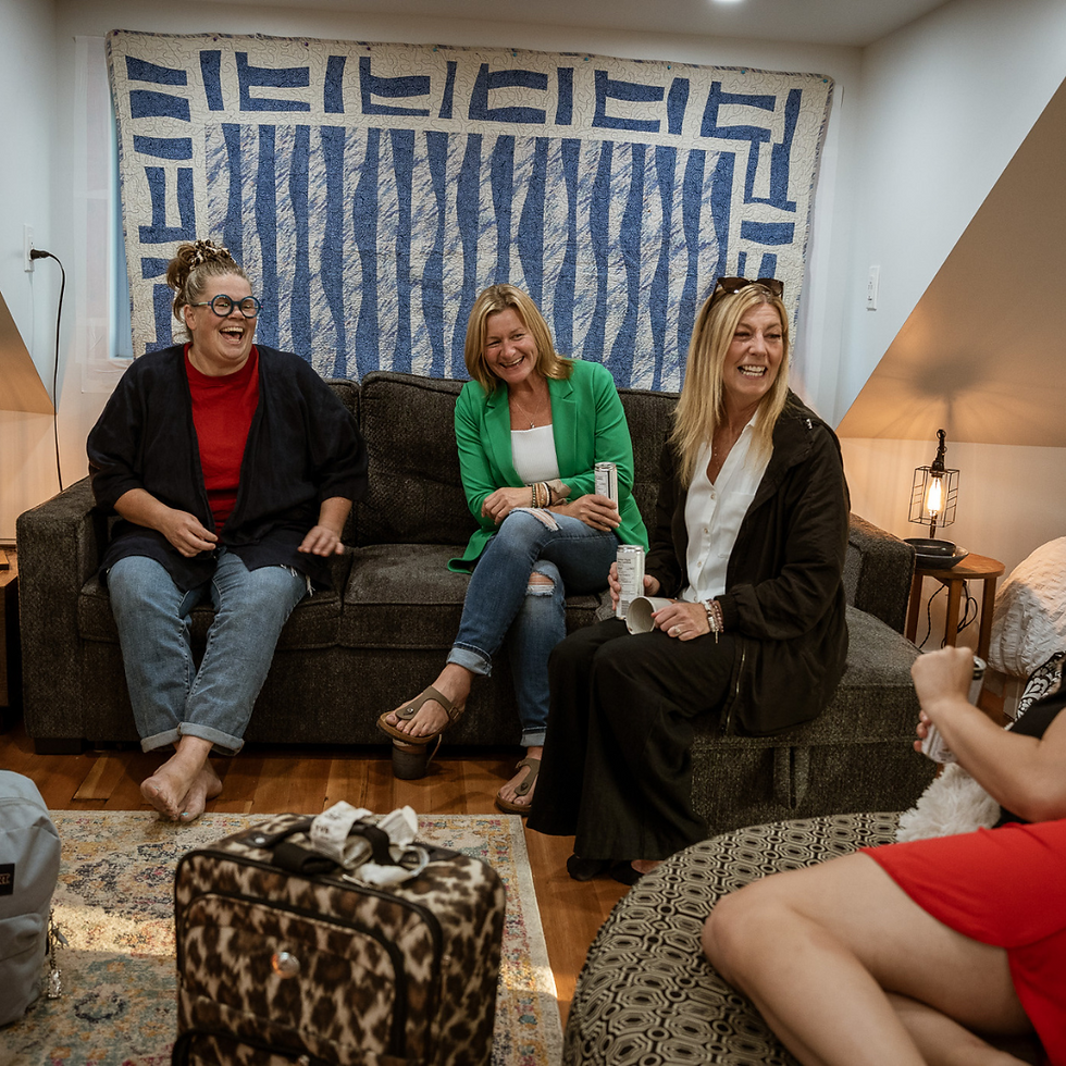 Guests gathered around a pottery table at Freba Pottery’s Claycation retreat, smiling and working with clay, surrounded by natural light and prairie-inspired decor.”