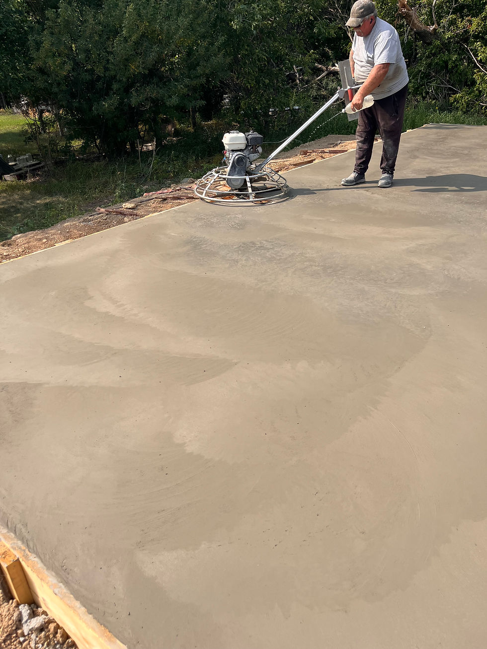 "Freba Pottery Schoolhouse update with fresh concrete foundation, sunny prairie sky, and open fields ready for the next stage of Claycation"