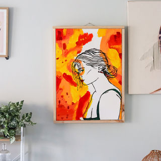 A bright yellow and red themed painting with a wooden frame. 